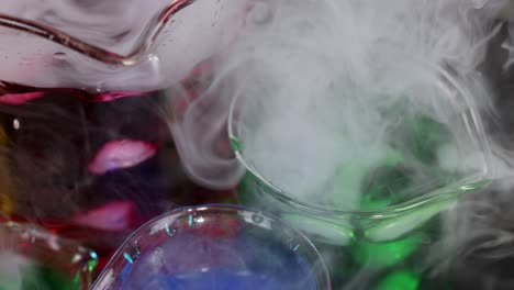 beakers with colorful liquids and dry ice reaction