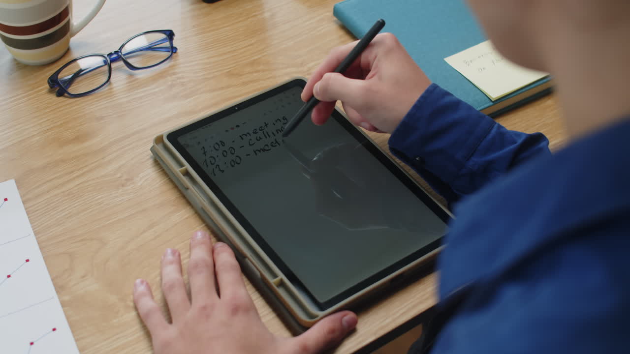 Unrecognizable Manager Writing Working Schedule with Pen on Tablet