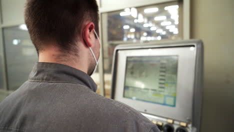 factory worker operating a machine