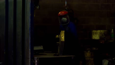 worker using hand grinder machine in foundry workshop 4k