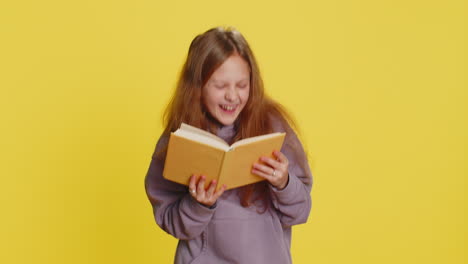 happy child girl kid reading funny interesting fairytale story book leisure hobby learning study