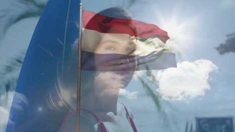 dutch flag and animation of woman's face with bright sky and palm trees
