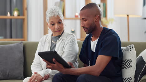 doctor discussing tablet with elderly patient
