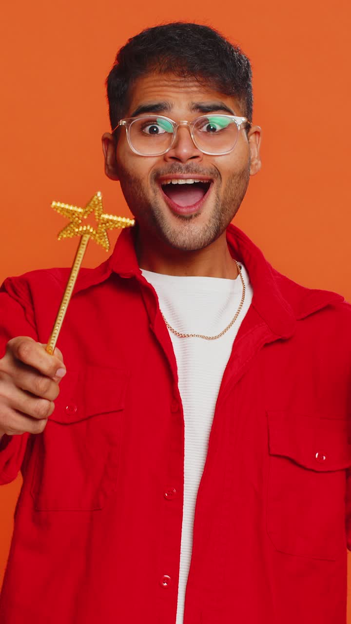 Magician wizard young man gesturing with magic wand making wish come true casting magician spell