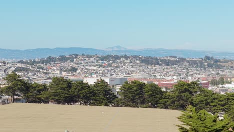 elevated perspective shows bernal’s patchwork of yards, gardens, and walkable streets framed by fog.