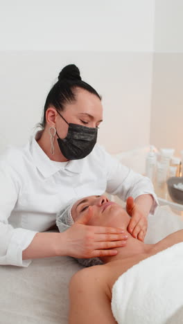 cosmetologist applying special moisturizing cream scrub chemical peeling face of pretty woman girl