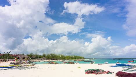 Fishing-wooden-boats-moored-on-the-beach-at-Kendwa-village,-sunny-day-with-clouds,-Zanzibar,Tanzania,-time-lapse-30-fps