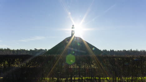 wide shot time lapse of sun appearing behind obelisk on austerlitz pyramid