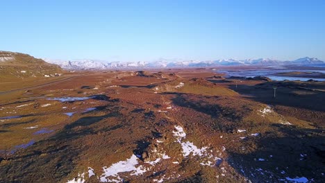 Iceland's-Scenic-Landscape-with-Aerial-Cinematic-Panning-Shot-with-Blue-Skies-Along-the-Coastline