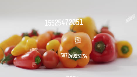 numbers and data animation over colorful bell peppers and tomatoes