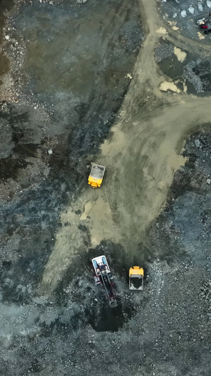 Aerial view of heavy machinery operating in a quarry or mining site