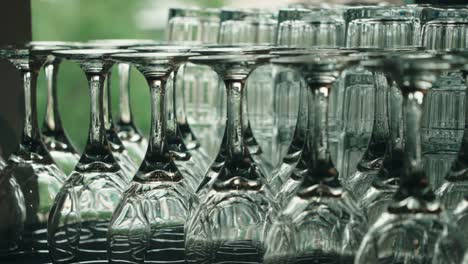 camera tilt up on neatly arranged wine and drink glasses for a formal event