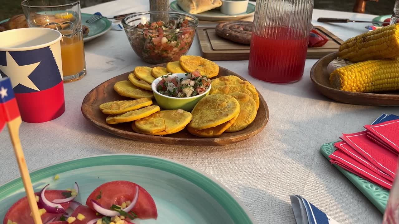 Fiestas Patrias chile grill parrilla meat chorizo table empanadas pebre sopaipillas