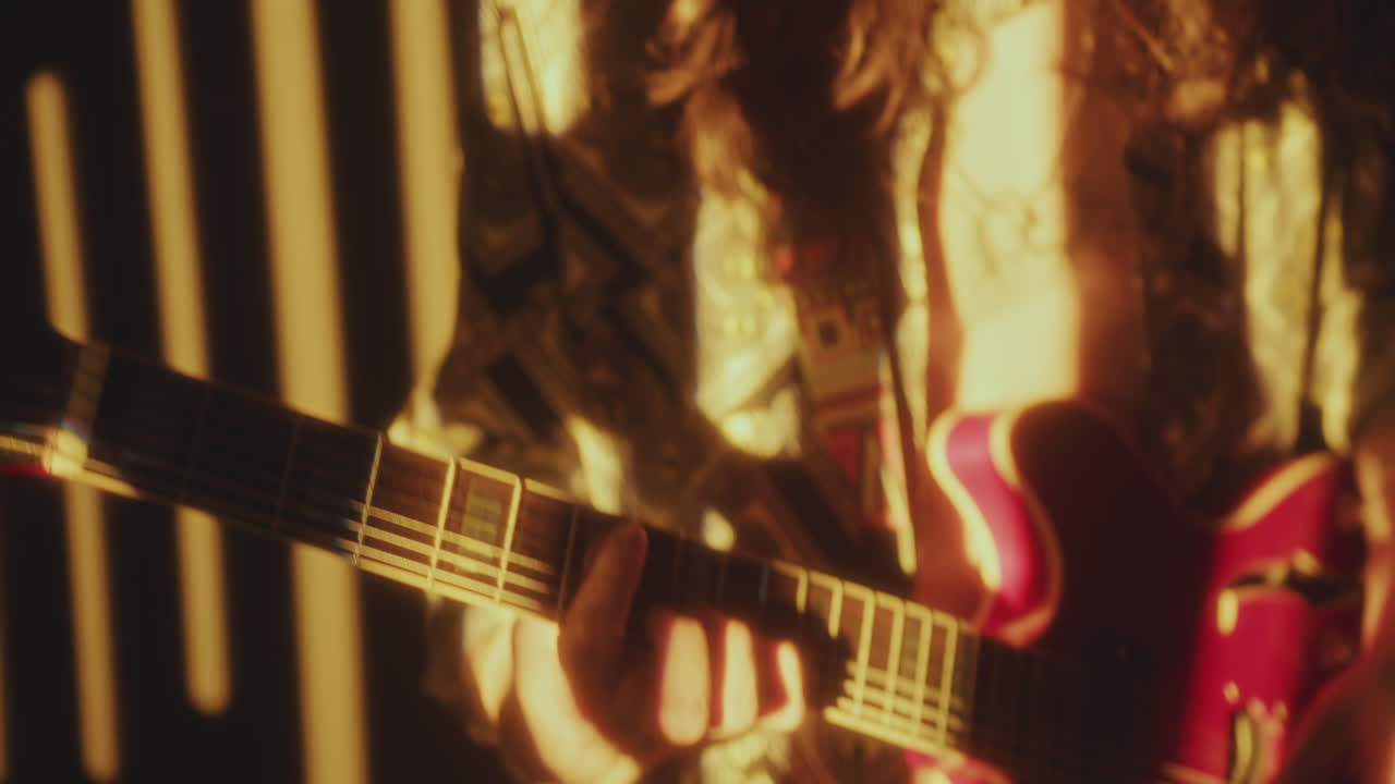 Young Music Artist Playing Electric Guitar in Warm Light Projection