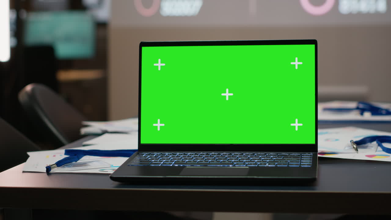 Boardroom table with a laptop running isolated mockup under night lights