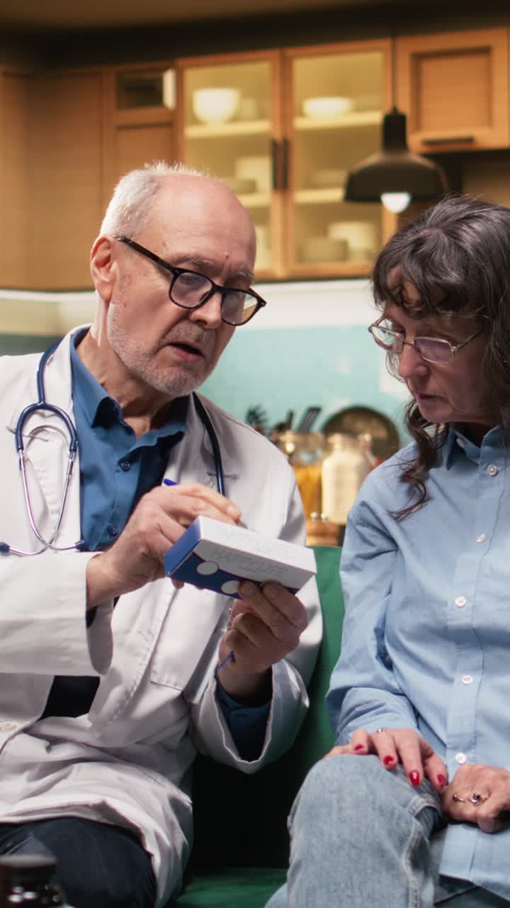 Vertical Video Male healthcare worker consulting old woman and provide medical pills