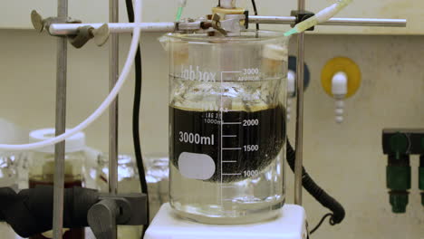 chemical solution being mixed by a machine for an experiment - tilt down, slow motion