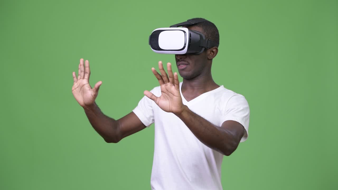 Young African man using virtual reality headset