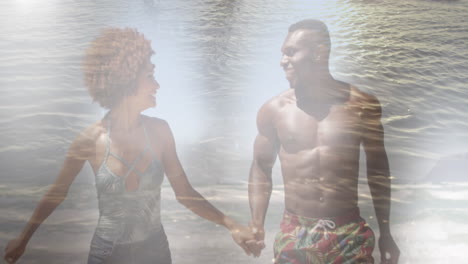 animation of happy african american couple at beach over sea