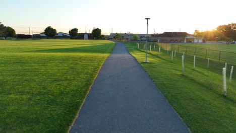 Reverse-aerial-view-of-walking-path-in-park