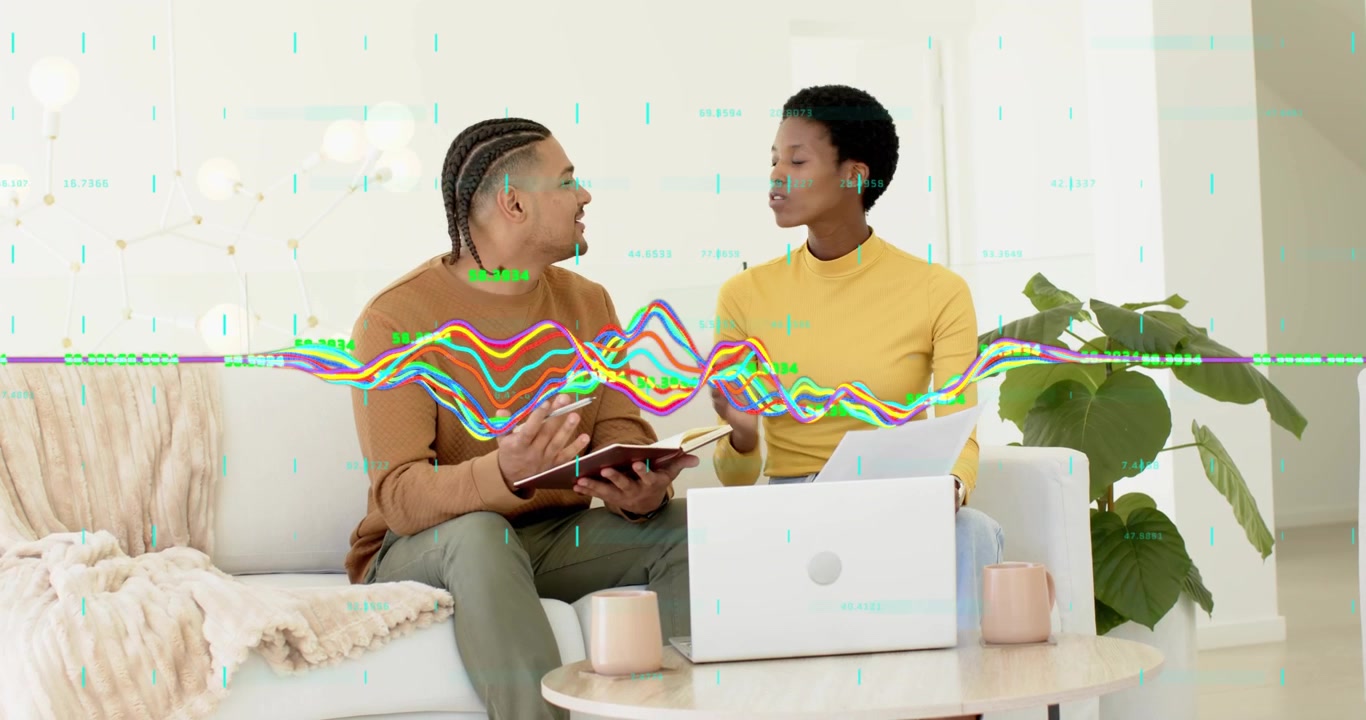 Remote couple reviewing finances on sofa, spotting discrepancy and correcting data on laptop