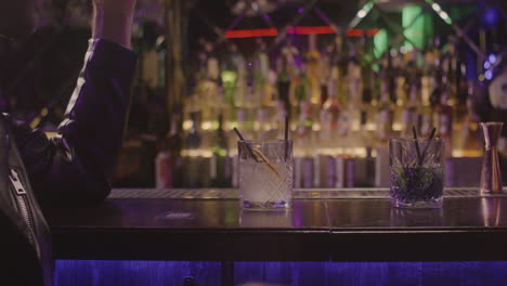 multiethnic couple drinking and talking together while sitting at bar counter