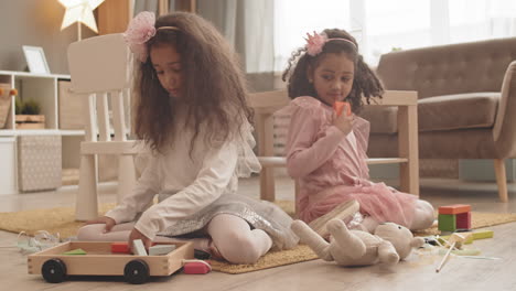 look-alike sisters playing on floor