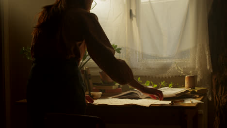 woman looking at pottery design sketches