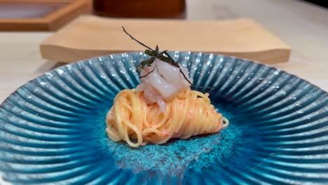 elegant noodle dish with seafood garnish