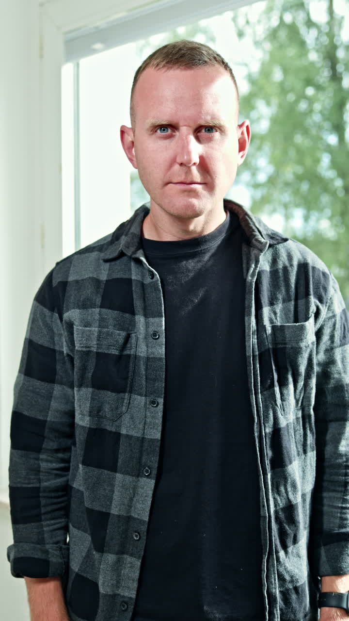 Emotional grimaces on a man's face close-up. A man looks grimly into the camera. A man's face with an angry expression on it. A man looks disdainfully in front of him