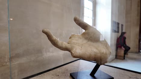 close up hand with fingers of the victory of samothrace in the louvre. greek sculpture detail nike.