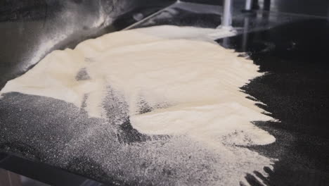 close up view of flour on a large black countertop