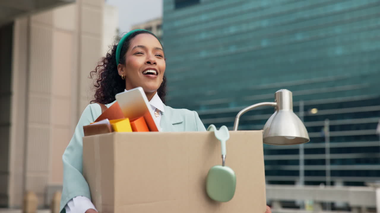 Woman with a cardboard box leaving her job