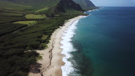 the beautiful, pristine white sand of the makua beach in oahu, hawaii - aerial