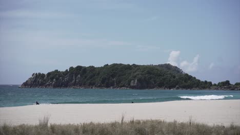coastal landscape with island, beach, and person