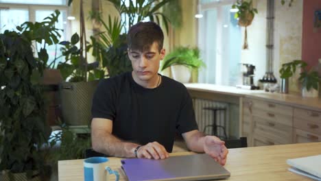 Young-european-Male-Student-is-angry-quit-from-the-coffeehouse-with-natural-background