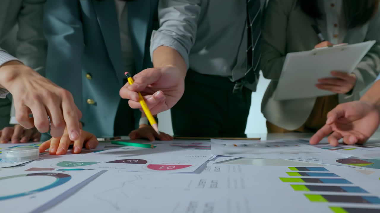 Close up Business team sharing his business ideas with colleagues during meeting in modern friendly workplace office, data analysis with laptop and paperwork, hands with pencil review market research.