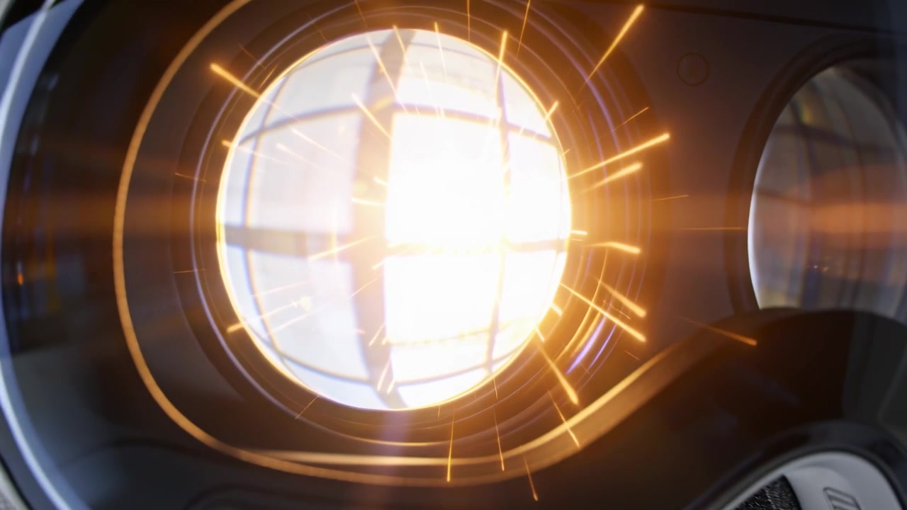 Reflecting VR goggles showing studio light causing growing circular glare, forming golden sparks