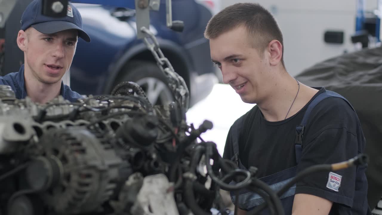 Auto Mechanics Repairing a Car Engine