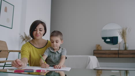 Young-Woman-And-Child-Drawing-Together-Making-Picture-With-Pencils-In-Flat