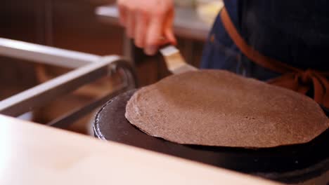 chef preparing crepe on the pan