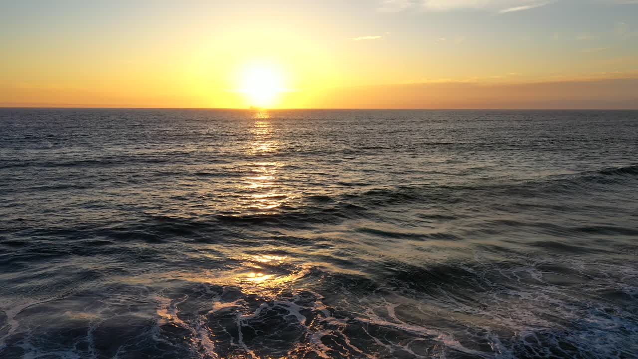 кадр полета дрона над морем на закате на побережье калифорнии