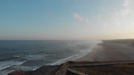 aerial of portuguese beach near lisbon at sunrise