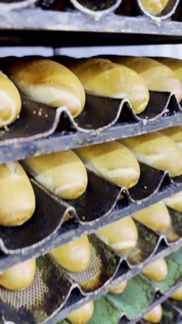 stacked baguettes on baking trays