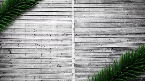 video composition with snow over pine frame on wood