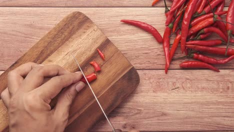 chopping red chili peppers