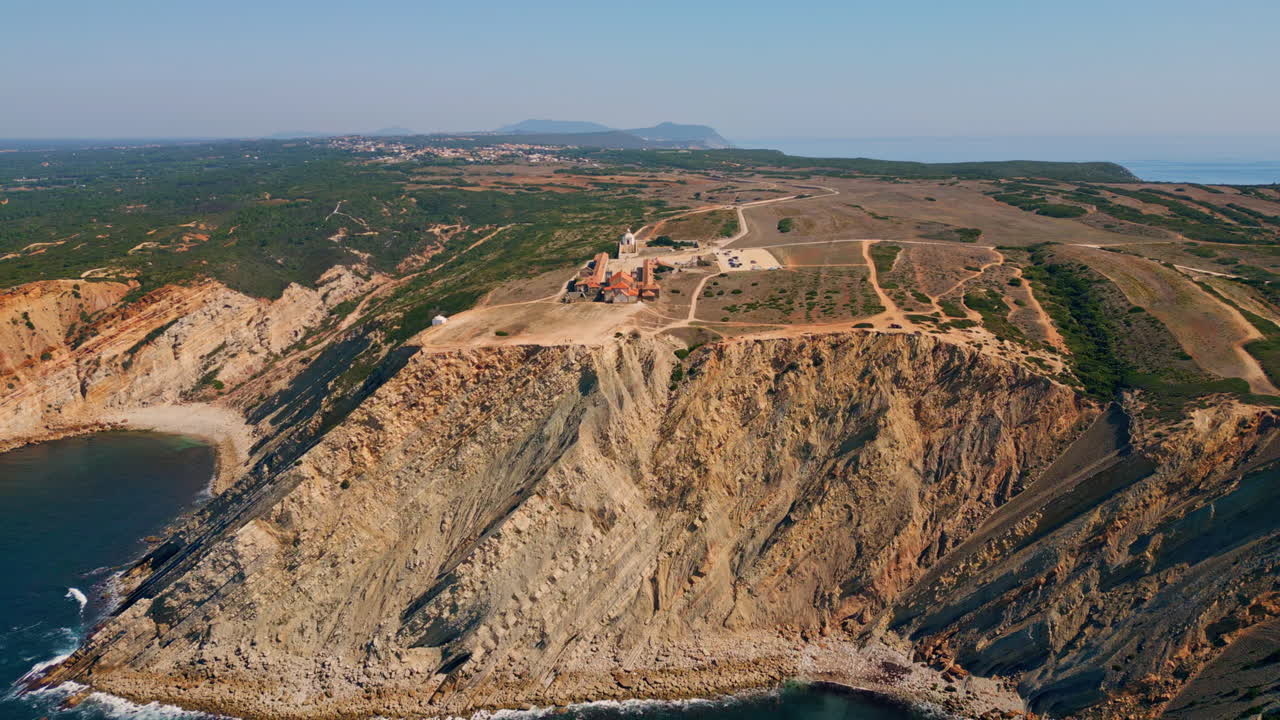 Wonderful coastal cliffs washed by turquoise ocean water drone view. Rough rocks