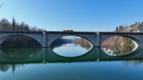 A-wonderful-aerial-view-over-the-Rhine-under-a-bridge,-past-a-village-called-Eglisau-in-Switzerland