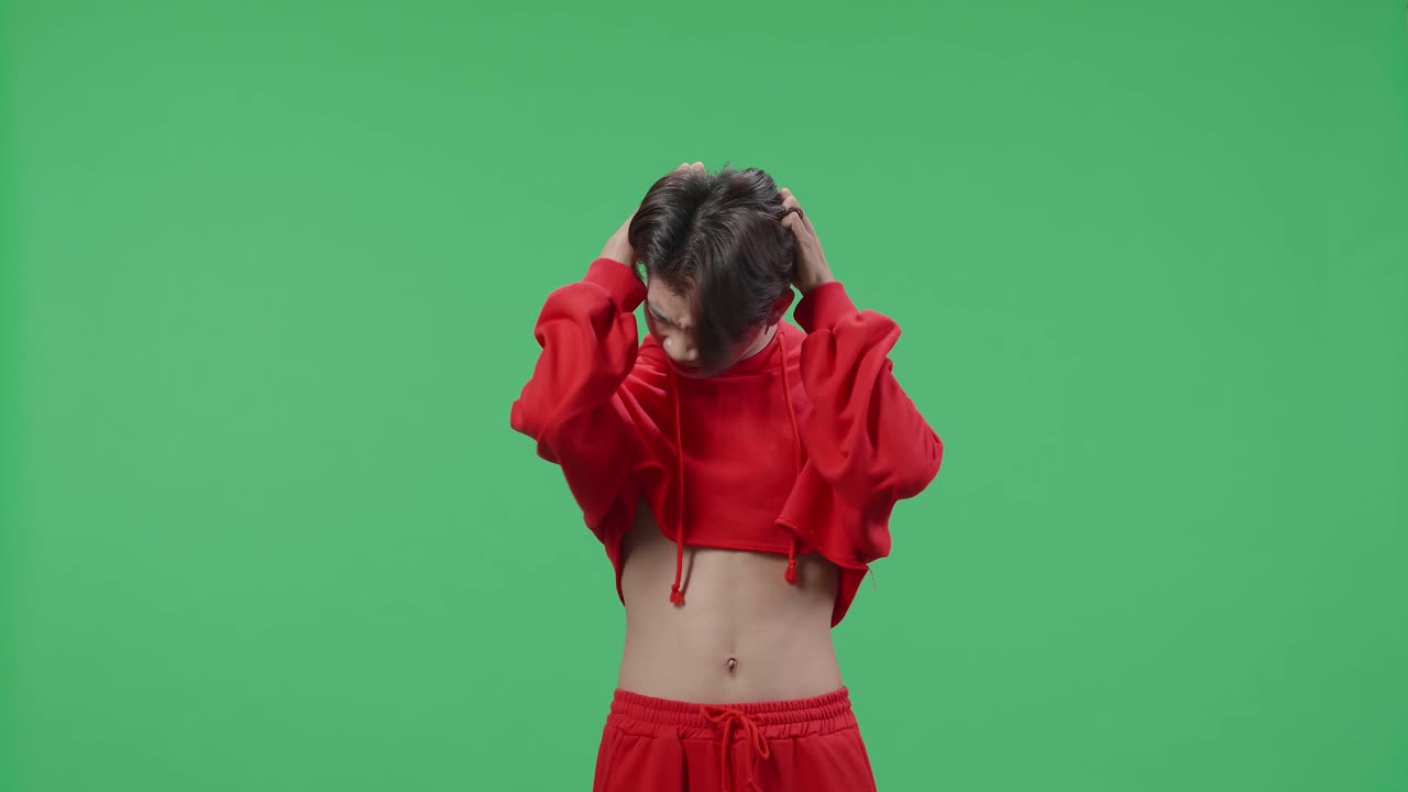 Upset Asian Transgender Male On The Green Screen Background