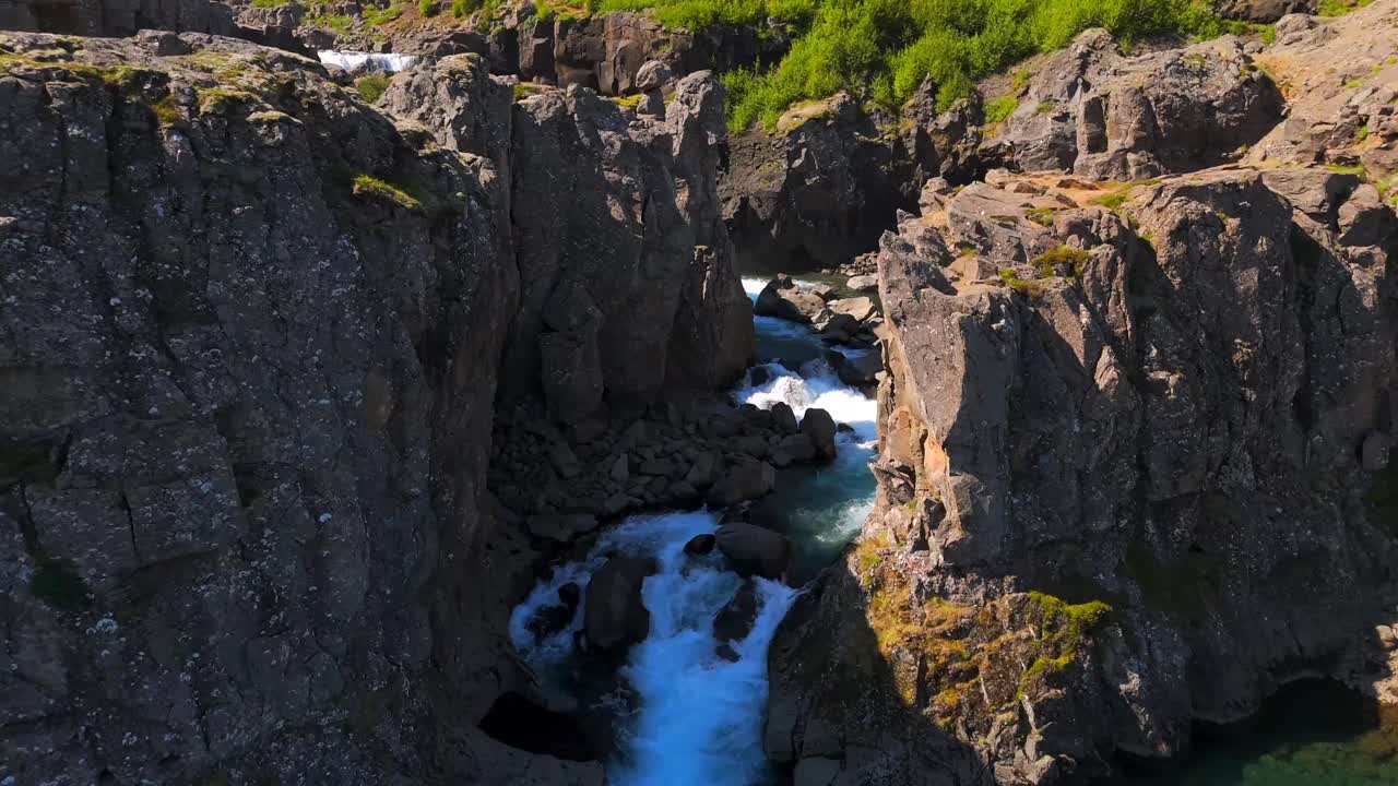 Fly over Egilsstaðir and witness the mesmerizing contrast of vibrant greenery against the rugged mountains, capturing the essence of Icelandic beauty.